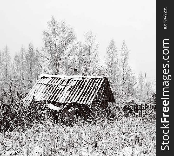 Old rural house in snow