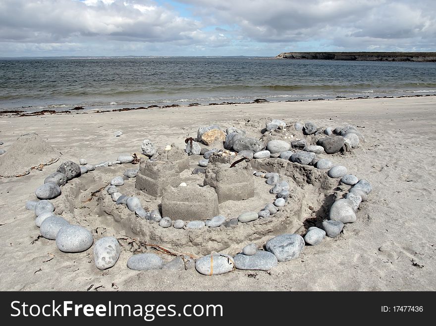 Beach sandcastle and pebbles