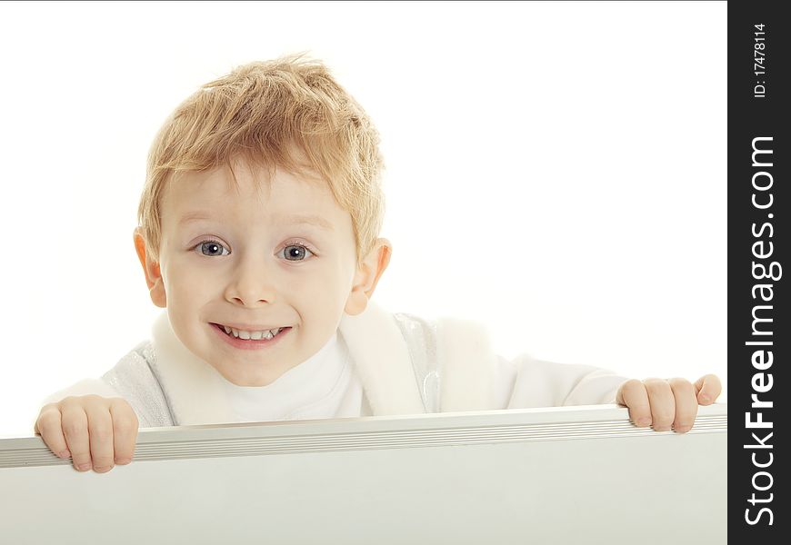 The little boy has control over a bulletin board and smiles. The little boy has control over a bulletin board and smiles