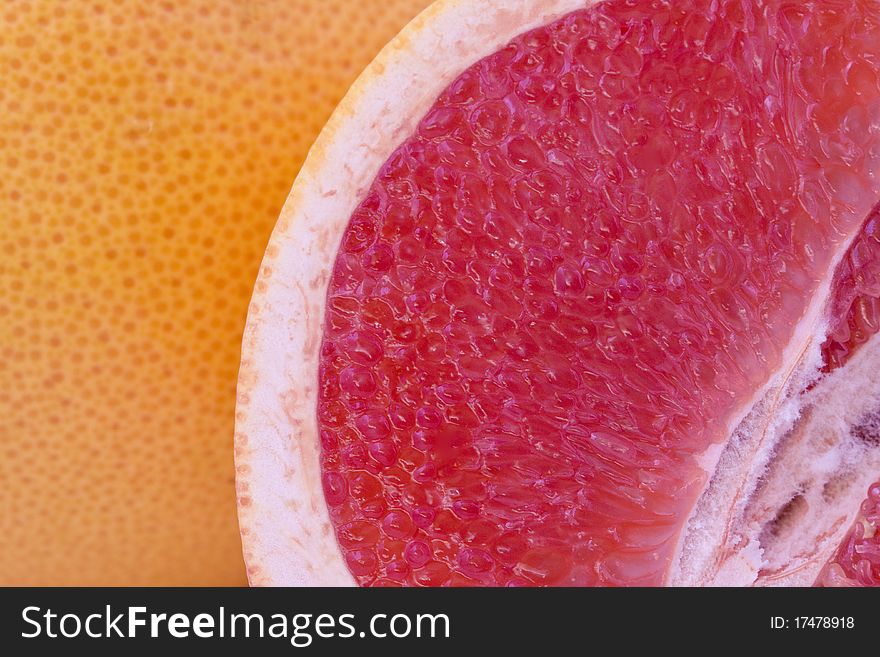 Fresh red grapefruit slice closeup, fruit background. Fresh red grapefruit slice closeup, fruit background