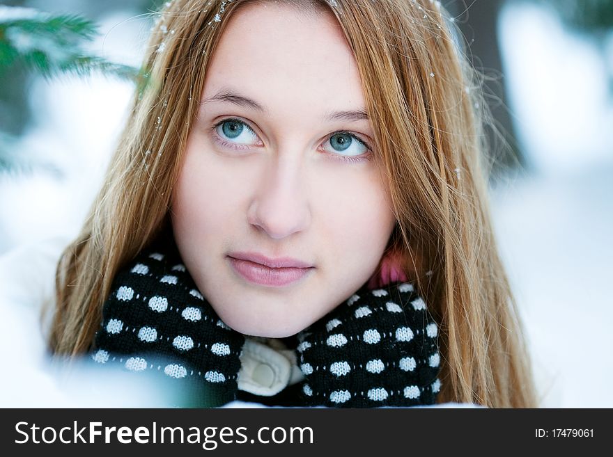 Cheerful girl in wood, winter, snow, a frost