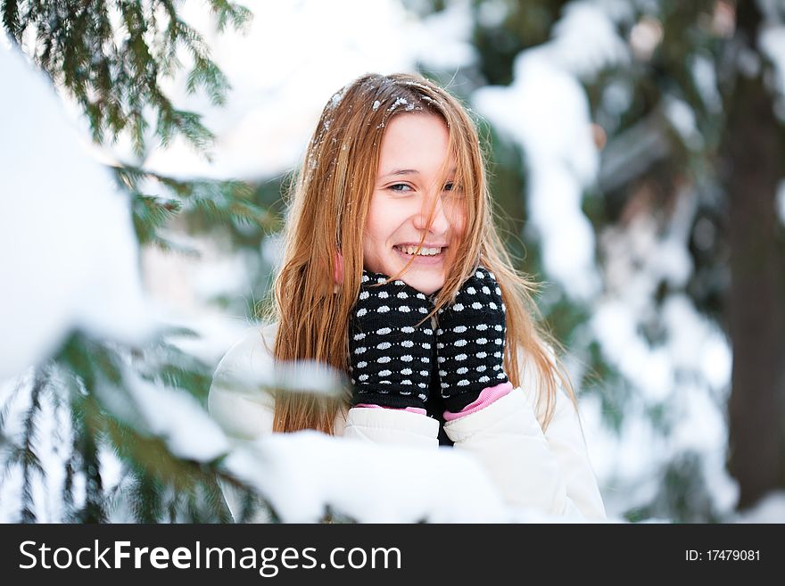 Cheerful girl in wood, winter, snow, a frost