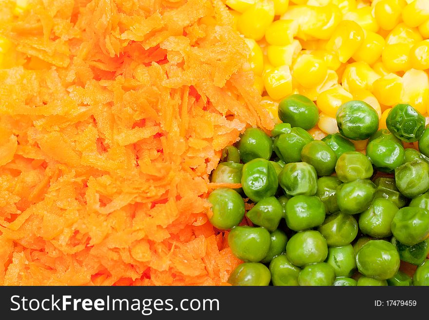 Boiled diced vegetables background with carrot, corn and peas