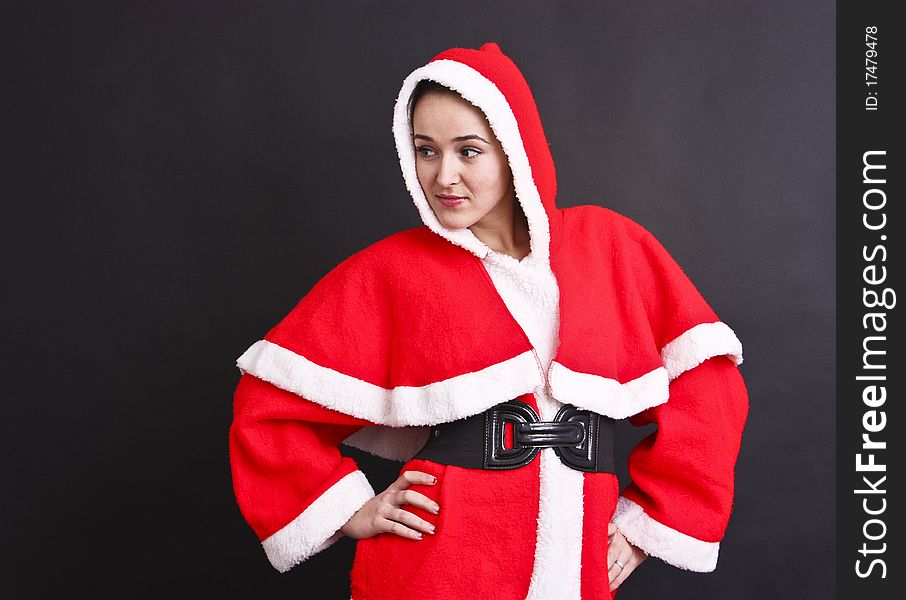 Portrait of a beautiful girl Santa,Santa clothes,black background