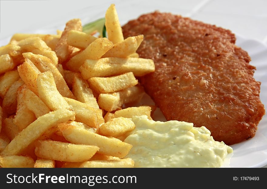 Fishcakes with french fries and tartar sauce. Fishcakes with french fries and tartar sauce