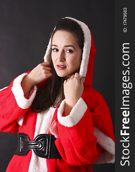 Portrait of a beautiful girl Santa,black background