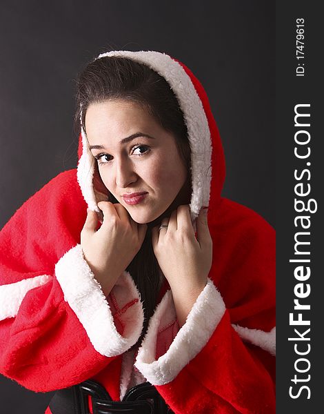 Portrait of a beautiful girl Santa,close-up.black background
