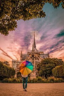 Young Woman Walking At Notre Dame Paris France ,sunset Colors Notre Dame Paris, Rainbow Umbrella Royalty Free Stock Photos