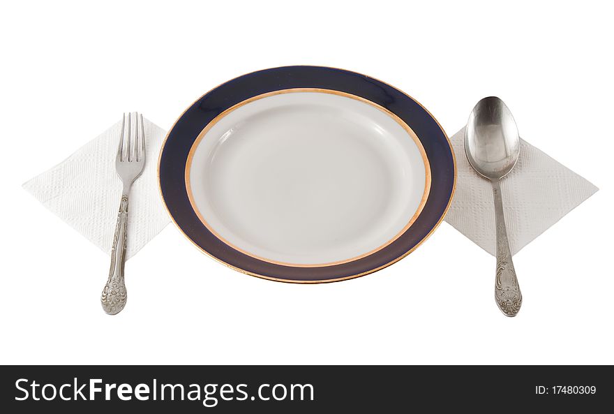 Steel fork and spoon crossed on plate