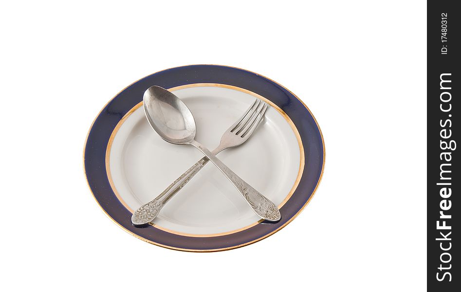 Fork And Spoon Crossed On Plate