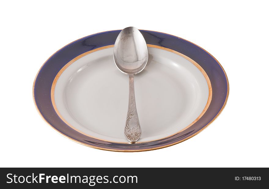 Steel fork and spoon crossed on plate