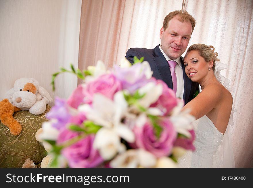 Bride and groom with a flower bouquet. Bride and groom with a flower bouquet