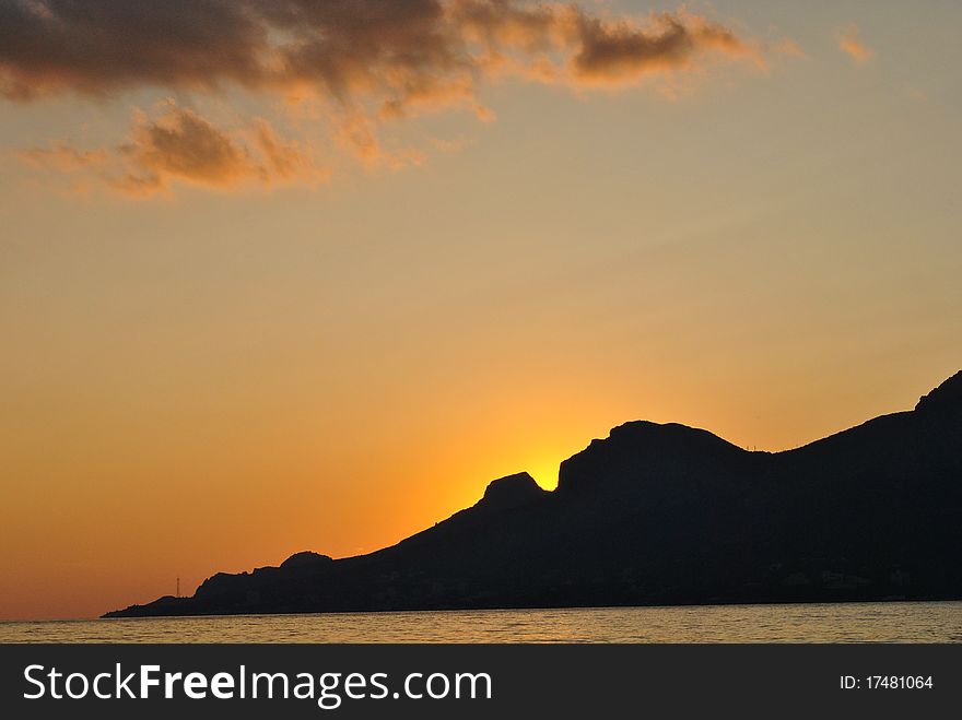 Sunset, sea and mountains