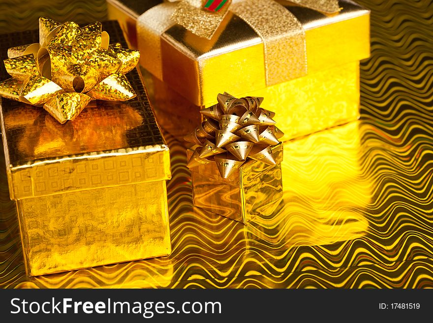 Festive gift boxes on golden background