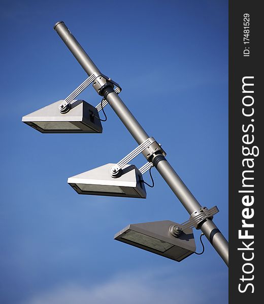 Lights on metal pole and blue sky. Lights on metal pole and blue sky