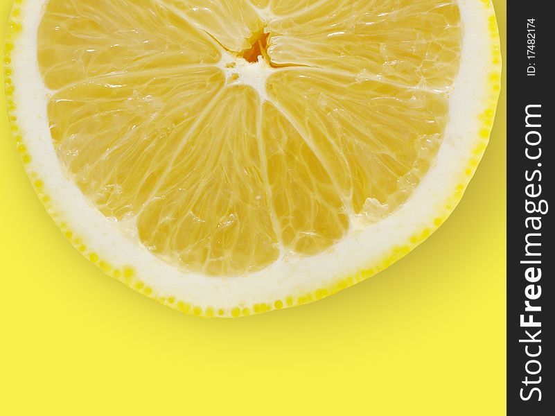 Lemon slice on yellow background