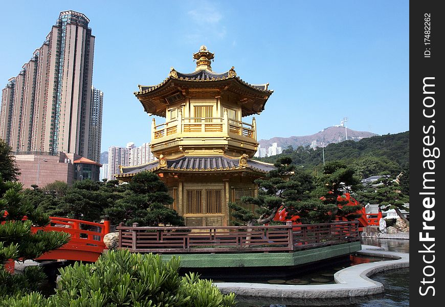 Small Chinese home in the garden and skyscraper. Small Chinese home in the garden and skyscraper