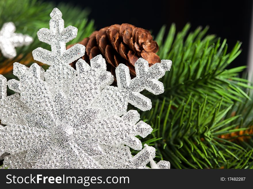 Branch of Christmas tree with snowflake