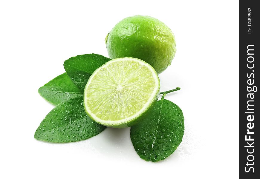 Green lemons with leaves on white background