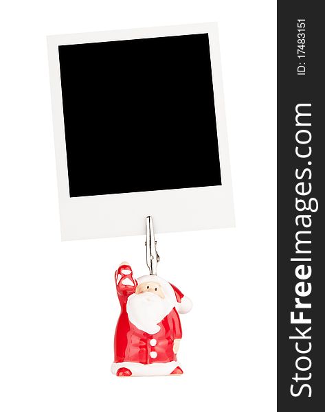 Photo holder in the form of Santa Claus with polaroid card isolated on a white background. Photo holder in the form of Santa Claus with polaroid card isolated on a white background.
