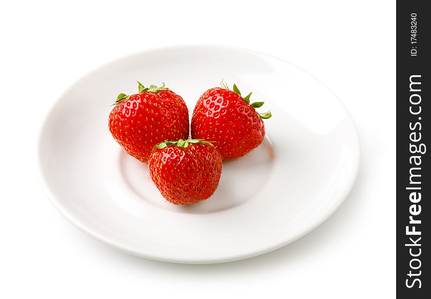 Three strawberries on the white plate. Three strawberries on the white plate