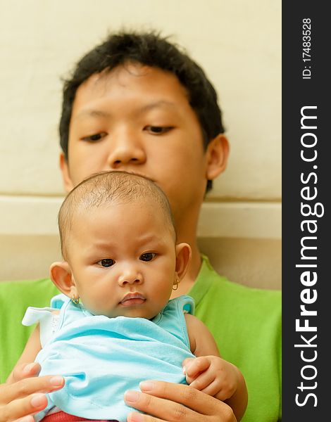 Asian Teen Boy Hold A Baby