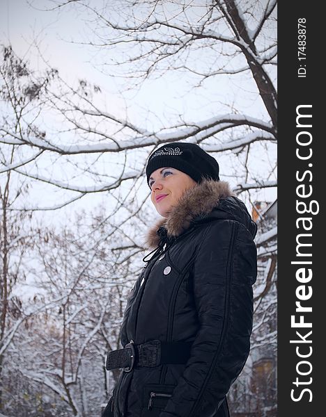 Portrait of the girl standing against winter trees. Portrait of the girl standing against winter trees