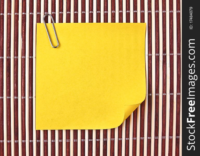 Yellow note and clip on mat. Yellow note and clip on mat