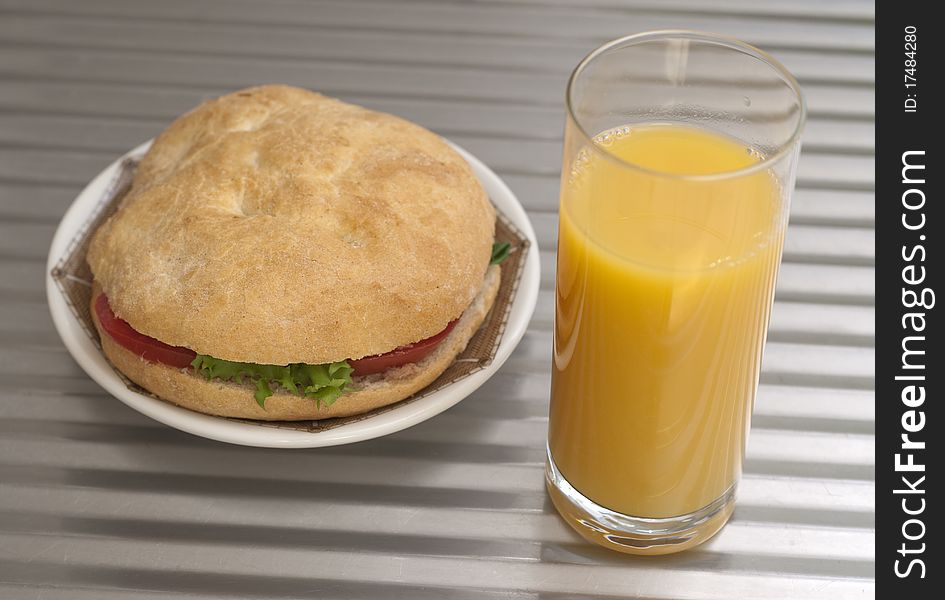 Delicious sandwich and a glass of orange juice. Delicious sandwich and a glass of orange juice