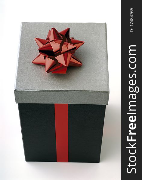 Gift in a box with red ribbon