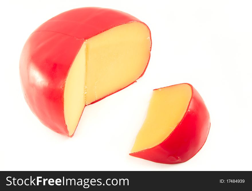 Cheese from holland with a slice cut out. White background. Cheese from holland with a slice cut out. White background