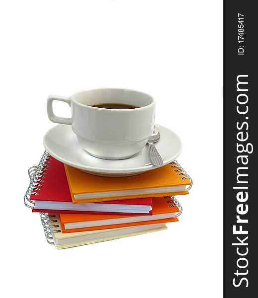 White coffee cup on the note book