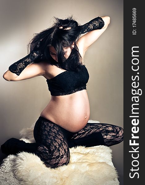 Pregnant woman in lacy stockings