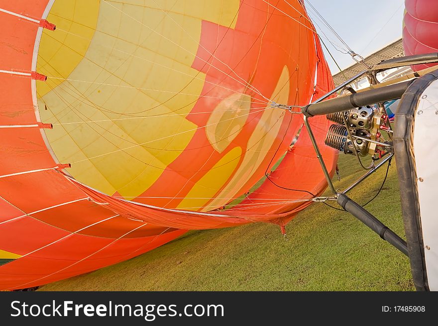 Yellow and orange hot air balloon on grass. Yellow and orange hot air balloon on grass.