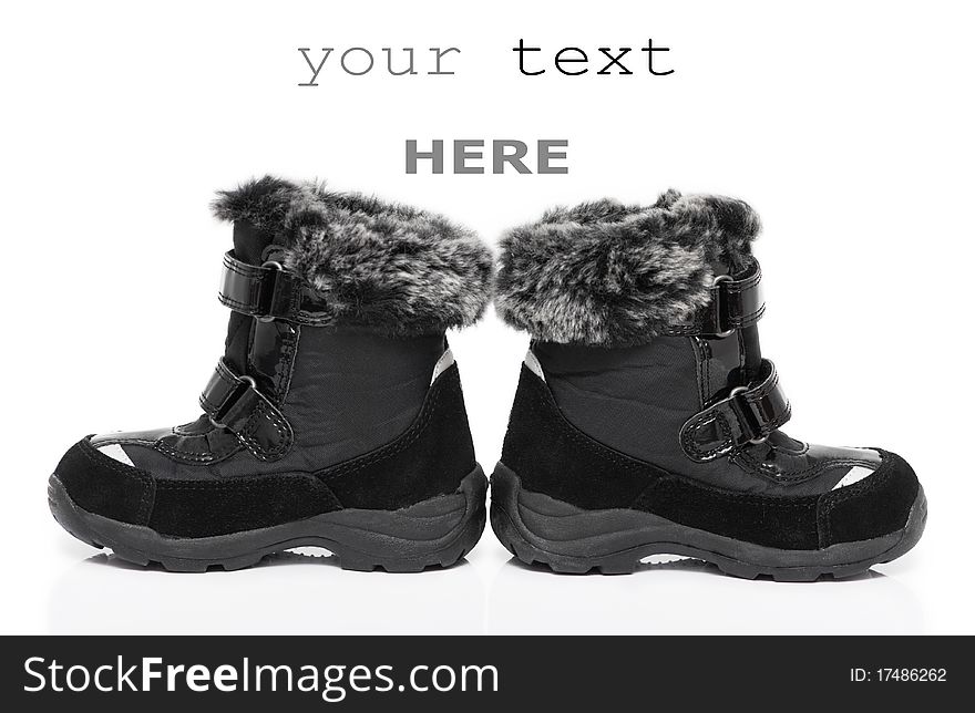 Black child's winter boots isolated on white background (with space for text). Black child's winter boots isolated on white background (with space for text)