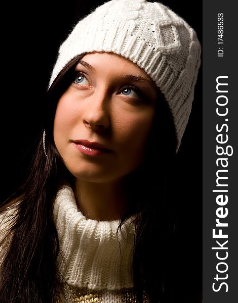 Photo of woman with white winter hat on black background. Photo of woman with white winter hat on black background