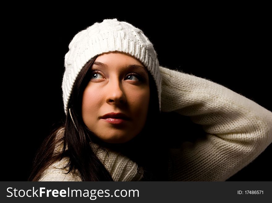 Photo of woman with white winter hat on black background. Photo of woman with white winter hat on black background