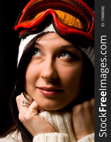 Photo of cute woman with snowboard mask on black background