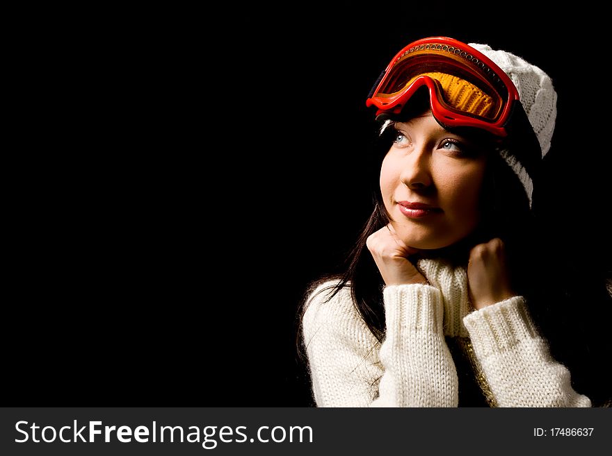 Photo of cute woman with snowboard mask on black background