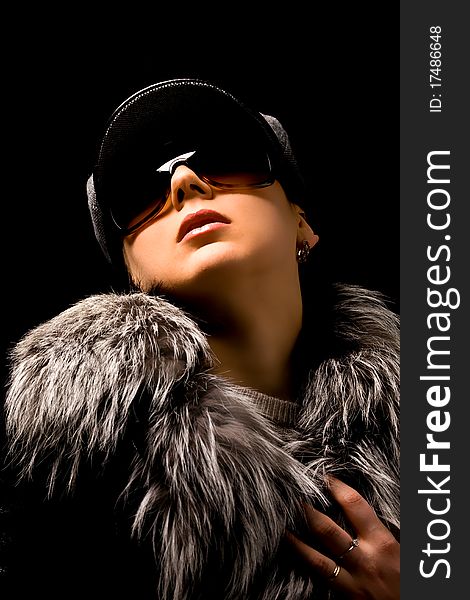 Photo of woman with furr and sunglasses on black background. Photo of woman with furr and sunglasses on black background