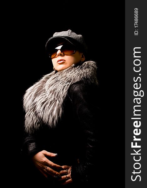 Photo of woman with furr and sunglasses on black background. Photo of woman with furr and sunglasses on black background