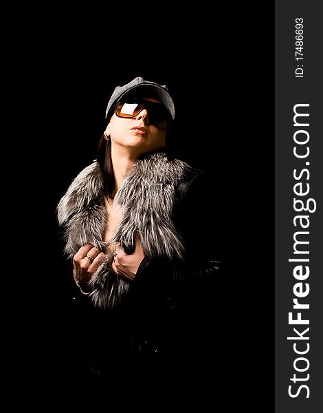 Photo of woman with furr and sunglasses on black background. Photo of woman with furr and sunglasses on black background