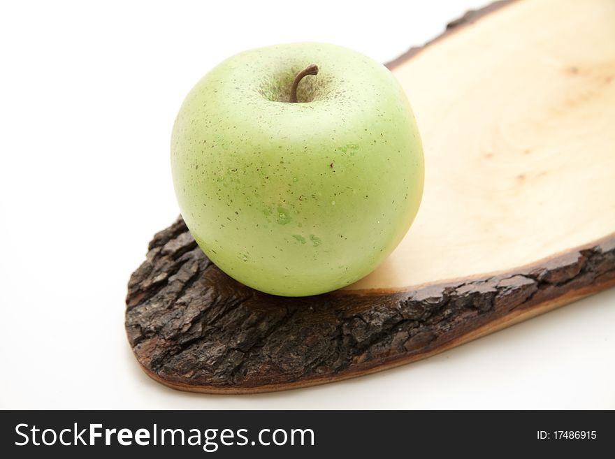 Apple on wood with bark