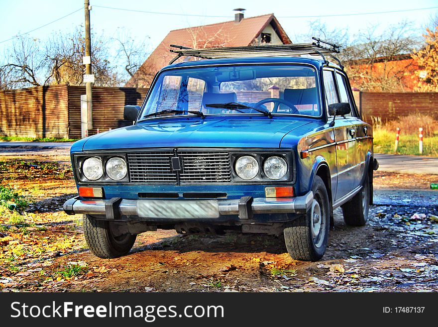 Russian old car Lada VAZ-2106 in HDR with country house on background. Russian old car Lada VAZ-2106 in HDR with country house on background.