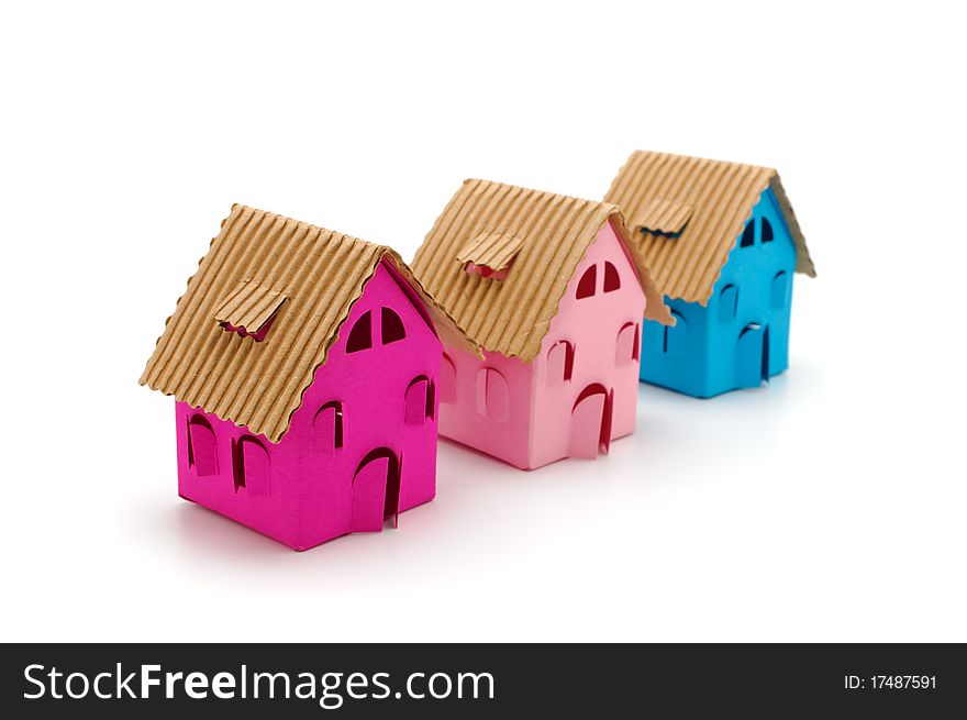Three color paper small houses on a white background. Three color paper small houses on a white background