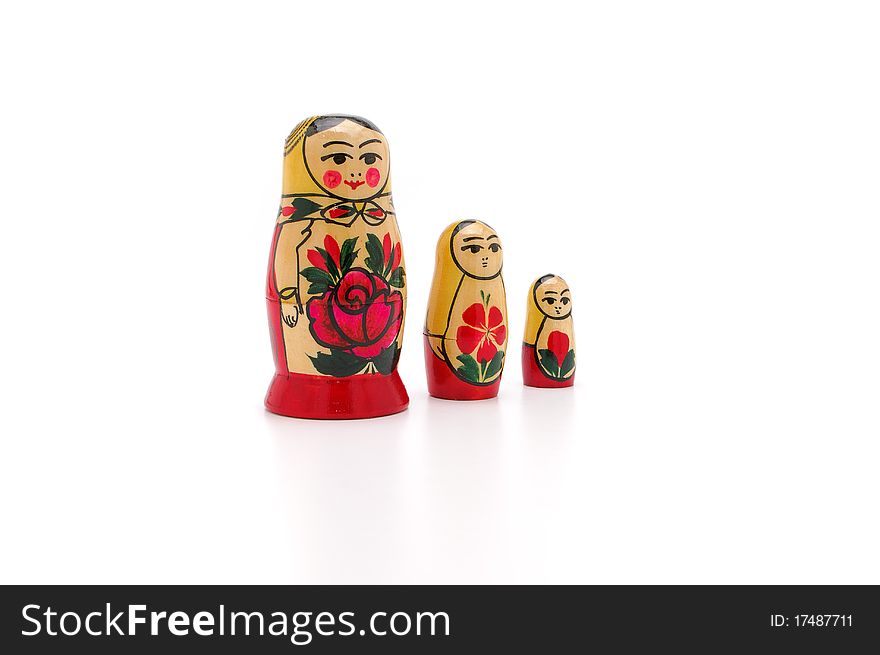 Three dolls of various sizes on a white background
