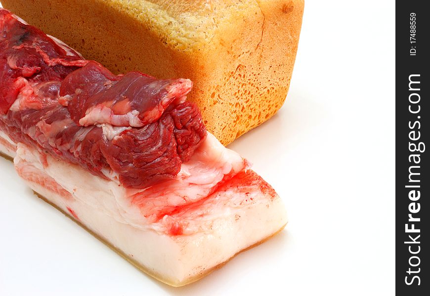 Bread and the big piece of meat on a white background