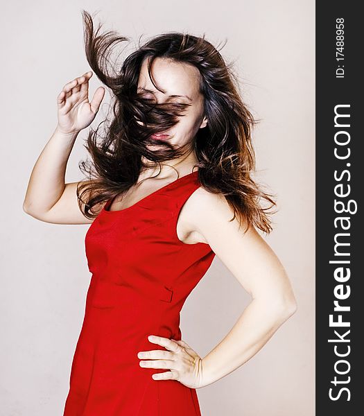 Beauty woman in red dress with hairs on the wind