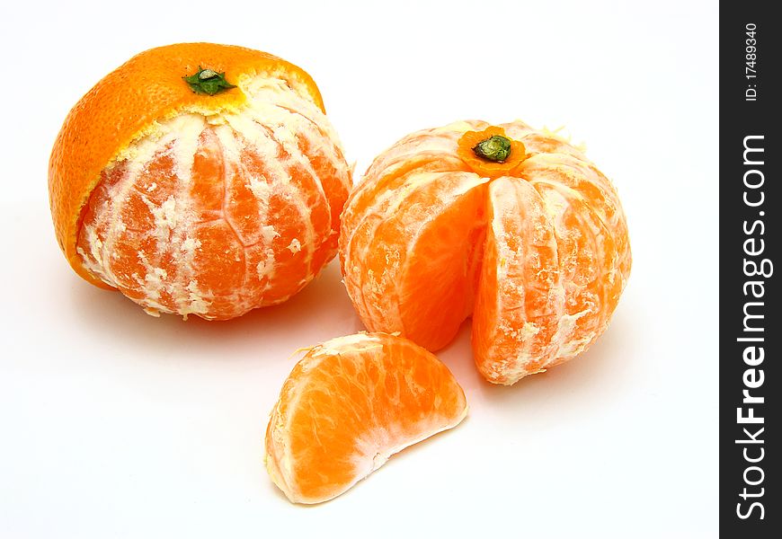 Ripe tangerines lie on a white background