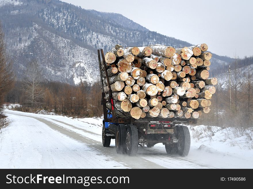 Winter driving on the highway transportation of timber in the car. Winter driving on the highway transportation of timber in the car